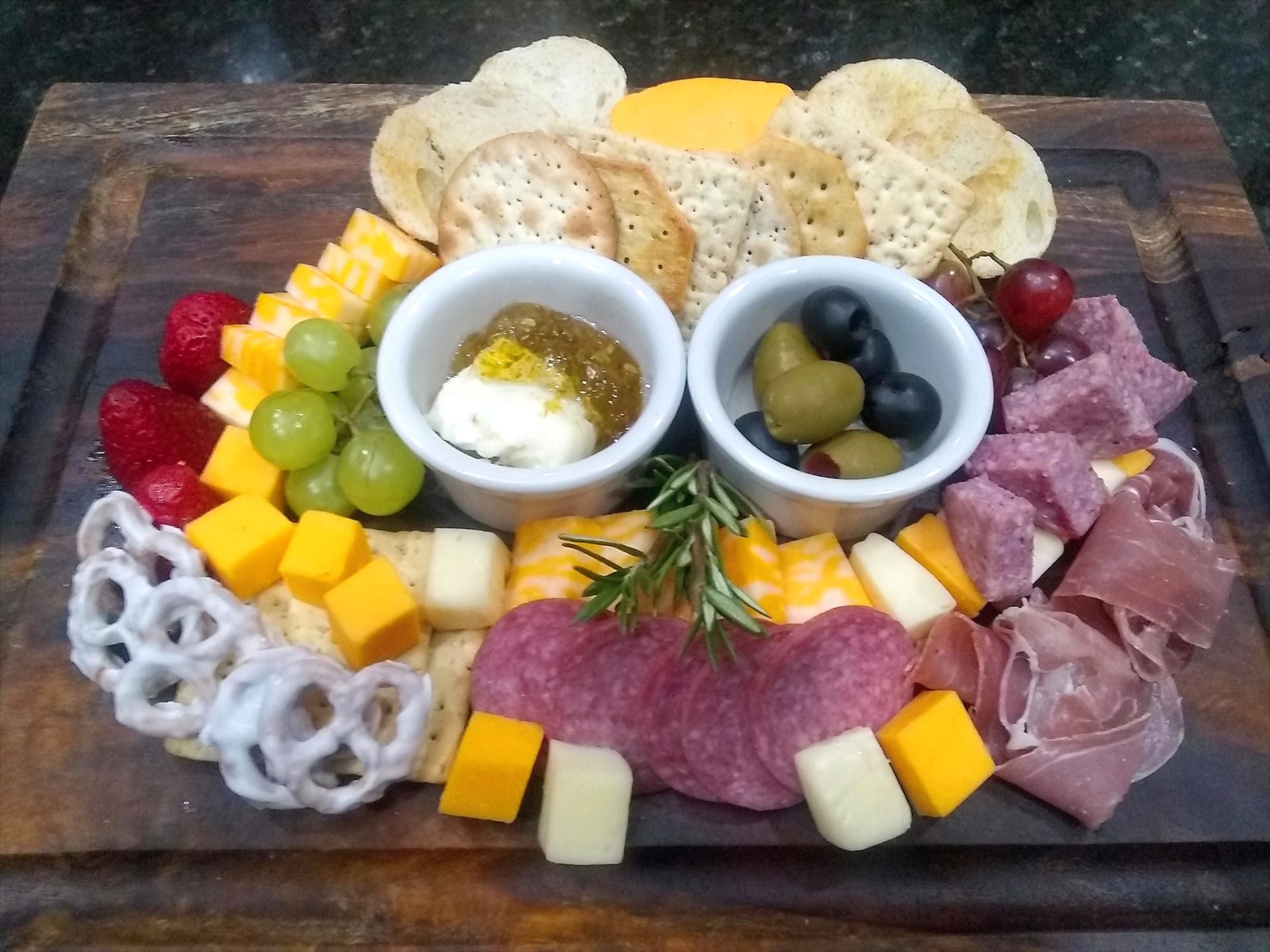 Individual charcuterie board with meats, cheeses, fruit and crackers